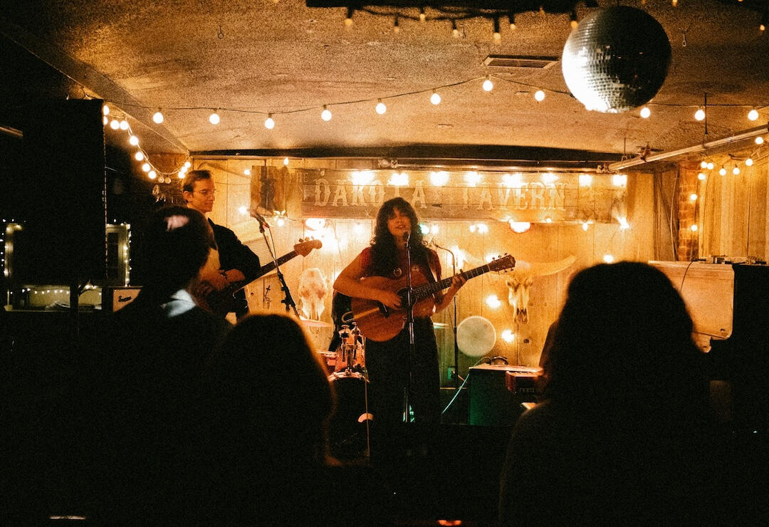 Photo by Vikram Singh. Photo of a band from the back of a crowd
